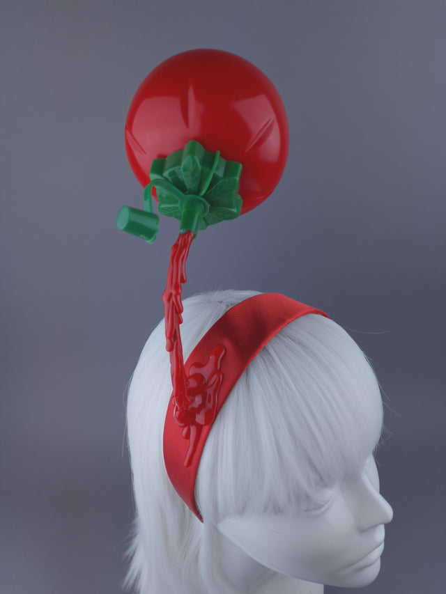 retro tomato sauce pouring on a red Alice band close up shot