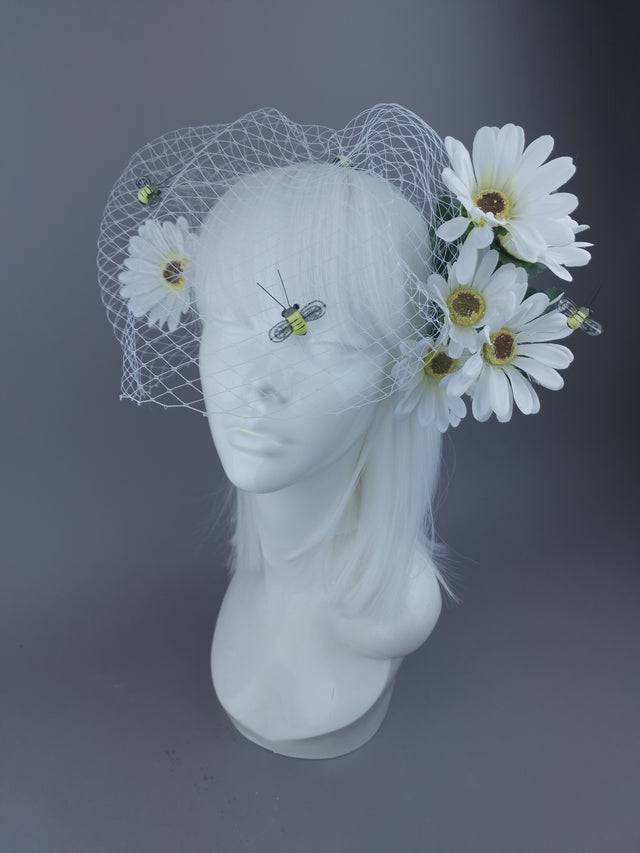 White headpiece with daisies and bee detailing, and netting veil