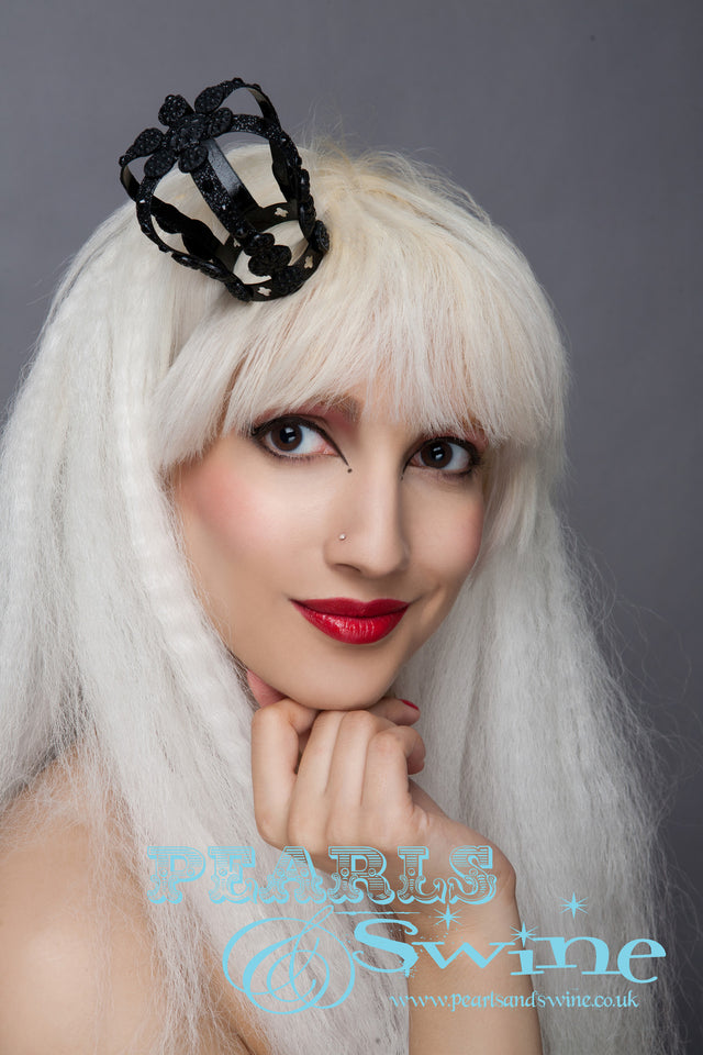 Limited edition black, mini light-weight metal crown decorated with black glitter, black crystals, and ornate black detailing. This crown attaches with adjustable hat elastic. This crown is perfect for lovers of goth fashion, a prom or a unique bridal headpiece.