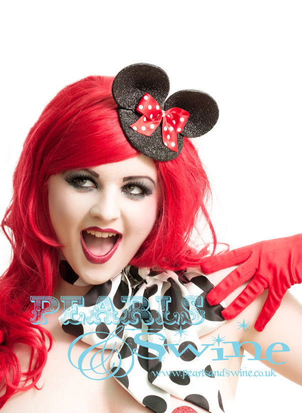 Black glittered mouse fascinator with glittered ears and a red & white polka dot bow. The base is backed with leopard print satin and attaches with a comb and adjustable hat elastic. This headpiece is very cute and perfect for a unique bride, it's the sort of fascinator you can wear without making a big statement but still having a quirky edge.