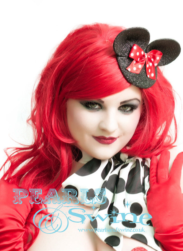 Black glittered mouse fascinator with glittered ears and a red & white polka dot bow. The base is backed with leopard print satin and attaches with a comb and adjustable hat elastic. This headpiece is very cute and perfect for a unique bride, it's the sort of fascinator you can wear without making a big statement but still having a quirky edge.