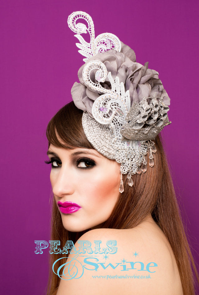 Silver Ship Fascinator "Tempest" One of a kind silver glitter ship, silver stiffened lace decorated by hand with clear crystals and grey silk roses and leaves. Set on a silver glitter fascinator base, dripping with clear fringe beading. The base is backed with leopard print satin and attaches with a comb and hat elastic. This would be a fabulous bridal headpiece!