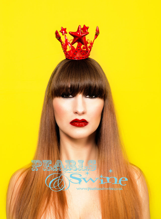 This red crown fascinator is inspired by the Virgin Mary, the mini red crown is hand-decorated with red crystals and red stars. Attaches to the hair with a comb and hat elastic.