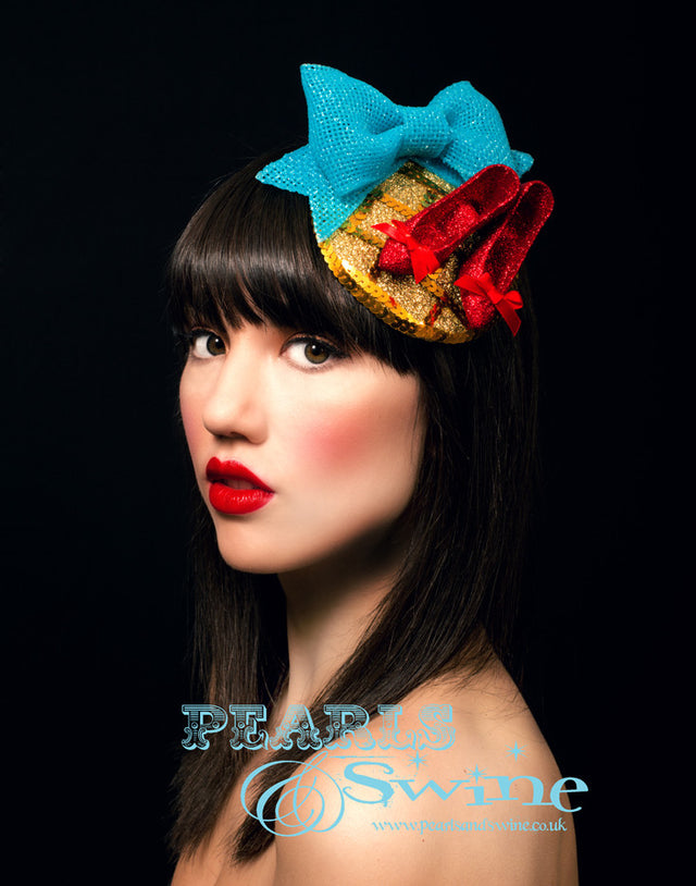 Wizard of Oz Fascinator "Follow the Yellow Brick Road" Wizard of Oz inspired fascinator, inspired by the Ruby Slippers. Featuring a gold hand glittered fascinator base (the yellow brick road) with sequins (bricks), hand glittered mini red shoes and a Dorothy blue bow. Backed with leopard print satin, this quirky but subtle Wizard of Oz fascinator attaches with a comb and adjustable hat elastic. This is perfect for fans of the Wizard of Oz!