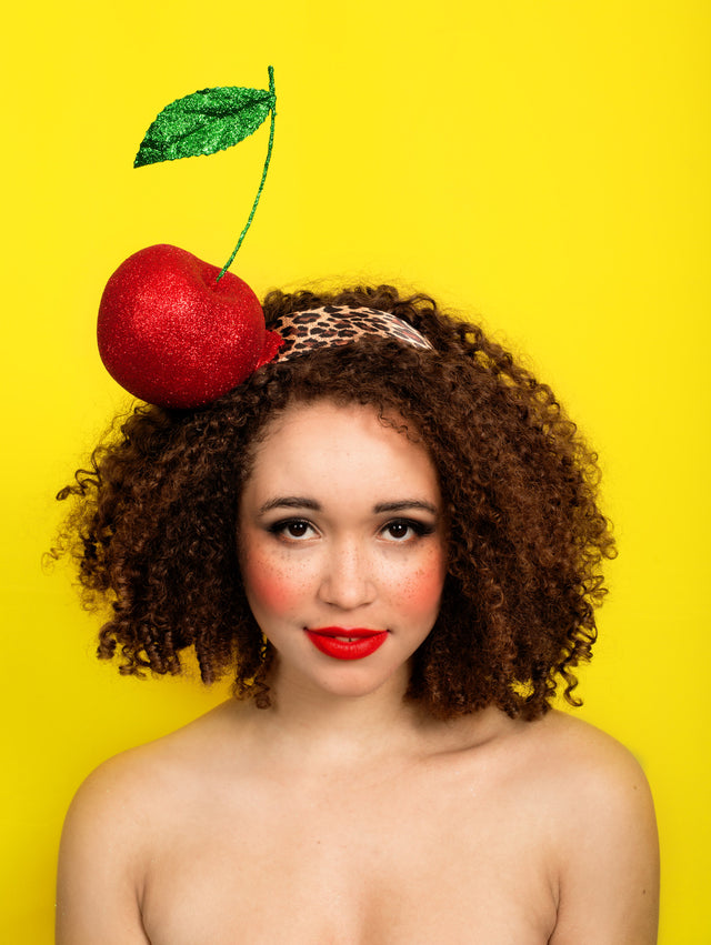 Limited edition giant glittered cherry headband is on a wide leopard print headband, dripping with red glitter with a green glittered leaf. This is light weight but bobby pins will help anchor if needed. Hand glittered so can be made up in other colours of glitter, just message me to ask. Perfect Royal Ascot headpiece or for a rock & roll bride.