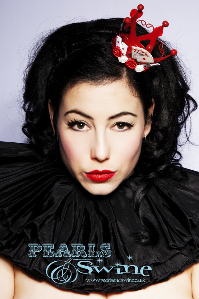 Red Mini Crown "Queen of Hearts" Red mini metal crown, decorated in roses, bows, playing cards, and symbols. This queen of hearts inspired crown attaches with a comb and adjustable hat elastic. Perfect for an Alice in Wonderland inspired outfit.