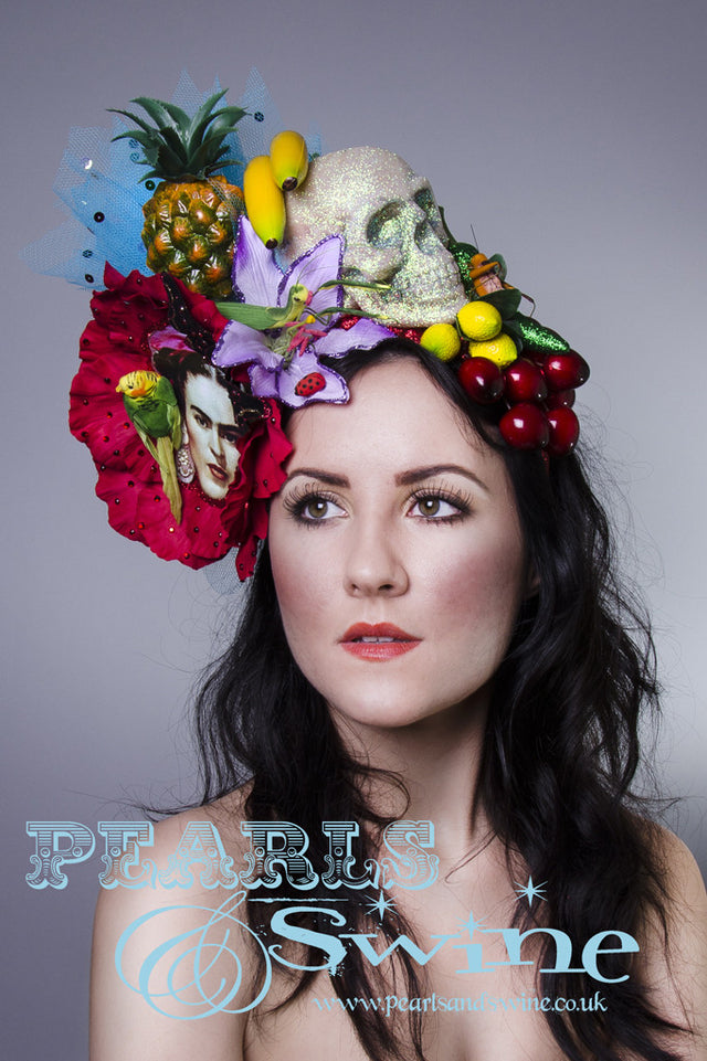 One of a kind Frida Kahlo inspired headdress has a giant red flower, fruit, insects, a glittered skull, a bird, chillies, a printed image of Frida, crystals, net, and sequins, all set on a red glitter headband. Frida is one of my favourite inspirations and icons. She had such incredible style and creativity.