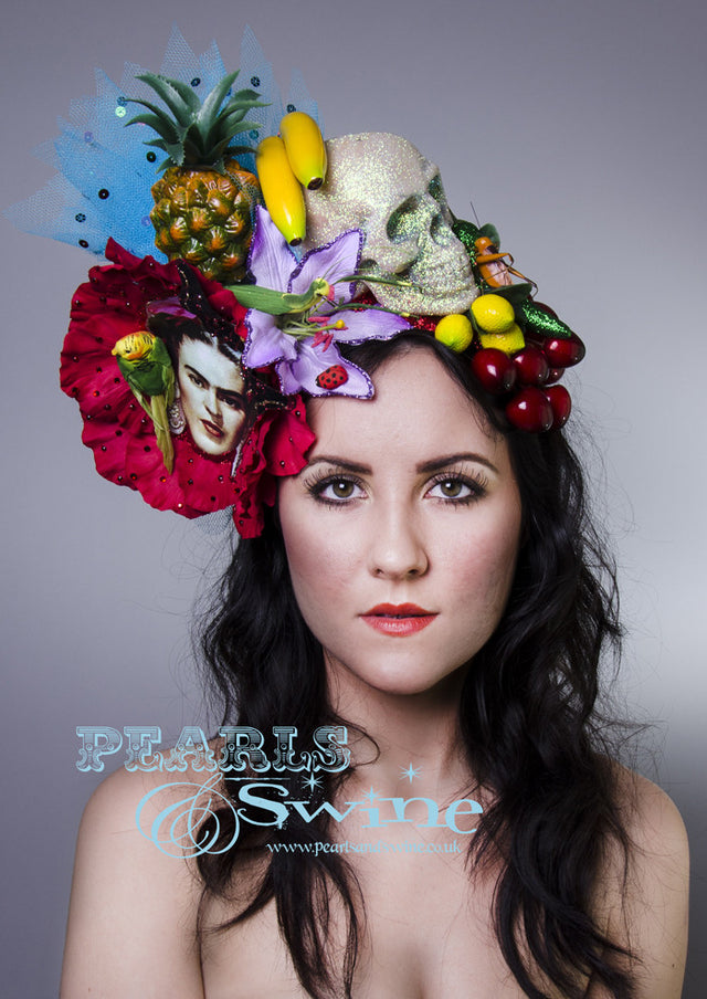 One of a kind Frida Kahlo inspired headdress has a giant red flower, fruit, insects, a glittered skull, a bird, chillies, a printed image of Frida, crystals, net, and sequins, all set on a red glitter headband. Frida is one of my favourite inspirations and icons. She had such incredible style and creativity.