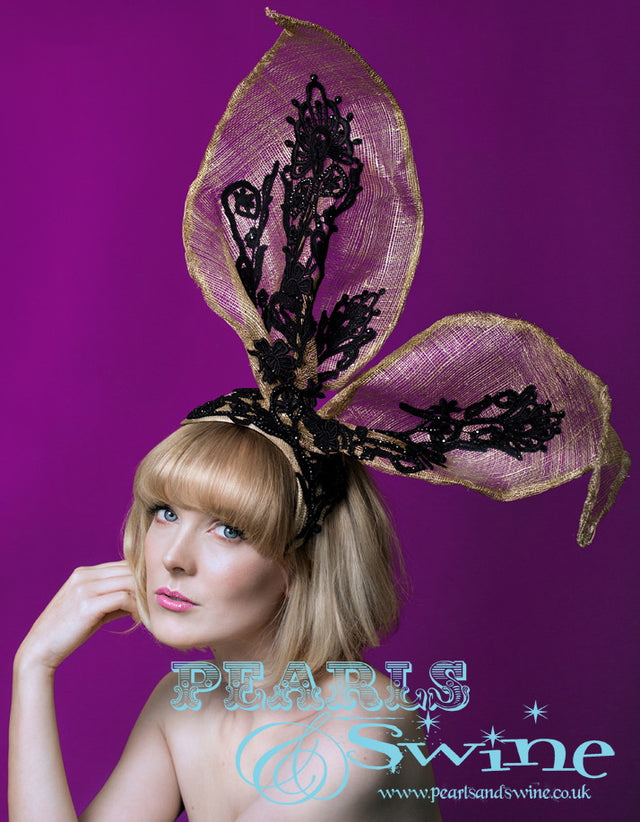 Giant gold and black lace bunny ear hat. Giant sinamay bunny ears with black lace decorated with hand placed black crystals set on a molded wired sinamay base. This is a one of a kind headpiece. Attaches with a comb and hat elastic, can be worn on either side or centrally. This is lightweight but if you need any extra securing just add bobby pins. Perfect for Ladies Day at Royal Ascot, a quirky bridal headpiece or a burlesque showgirl headdress.