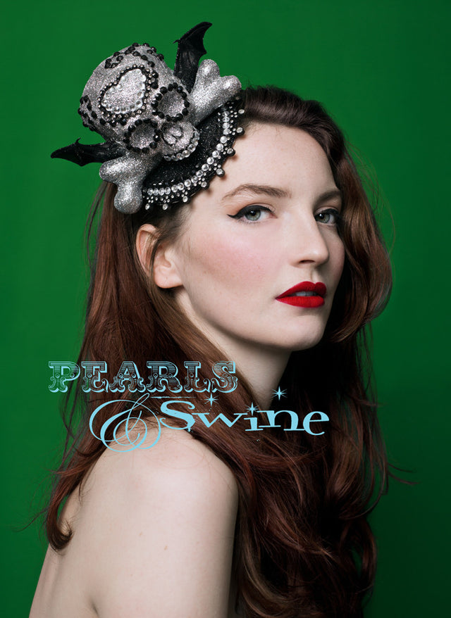 Skull & Bat Fascinator "Bella Muerte" Glittered silver skull decorated by hand with crystals, a bone and bat wings. Set on a black glitter fascinator base edged in a sparkly beading. Backed with leopard print satin and attaches with a comb and adjustable hat elastic. This Halloween fascinator is a little piece of wearable art, it would be fab to keep it on display in a glass cabinet when not wearing. Perfect Halloween fascinator or for goth fashion lovers.