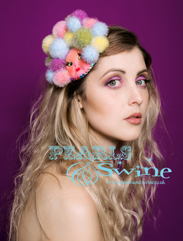 PomPom Doll Fascinator "Lolly Pop" Limited edition vintage doll face fascinator. Decorated with fake eyelashes, a pastel pompom afro and gems. Attaches with a comb and hat elastic. I have an obsession with doll faces, well... dolls but mostly dismembered and vintage. I paint these faces again to make them more hardwearing and unique. This lightweight headpiece is the sort of headpiece you can wear anywhere as it's not too big but it's still a "Say Something Hat". So perfect for a wedding!