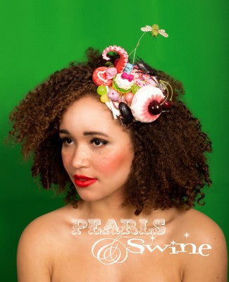 Surreal cake and candy covered fascinator covered in iridescent glitter decorated with sweets, cakes, tentacle, bee, cockroaches, lolly, skulls, cherries. Backed with leopard print satin this headpiece attaches with a comb and hat elastic. This is a cute and creepy headpiece, which demands a 2nd look.