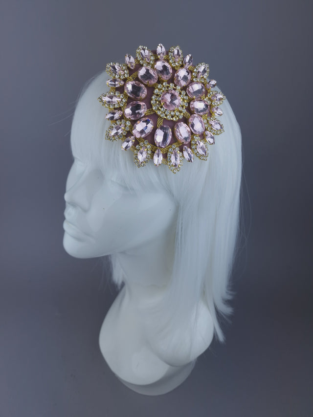 pale pink mini fascinator, decorated with a large sparkly jewel, set on a mini sinamay base covered in pink velvet.