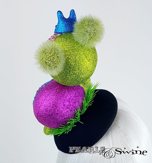 Intricately detailed doll face snail hat