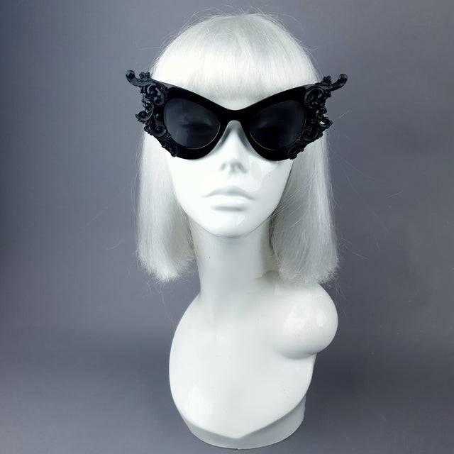 Hand-decorated black filigree ornate sunglasses, modelled on a mannequin head
