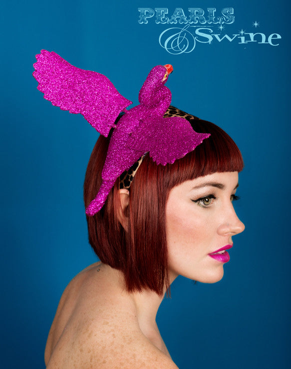 Flamboyant fuchsia pink glittered flamingo set on a wide leopard print satin headband. The wings even move slightly when you walk!!  Perfect for Ascot Ladies Day, The Doncaster Races, York Races, Kentucky Derby or an Alice in Wonderland inspired costume.
